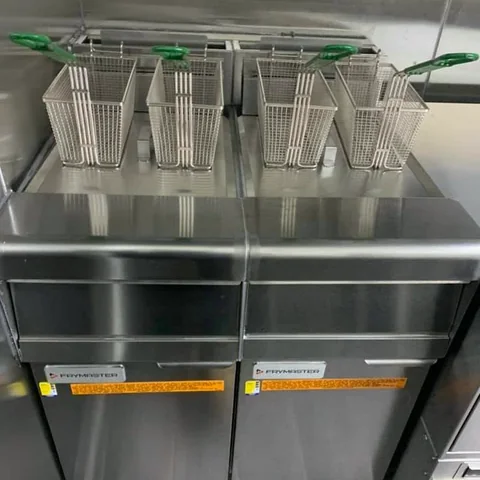 Stainless steel fryer baskets in a commercial kitchen, cleaned
