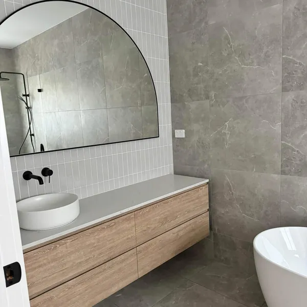 A cleaned bathroom vanity and mirror